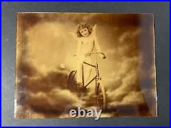 Antique 1896 Reverse Lithograph on Glass J Arthur Cherub Angel on Bicycle Heaven