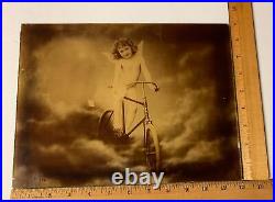 Antique 1896 Reverse Lithograph on Glass J Arthur Cherub Angel on Bicycle Heaven