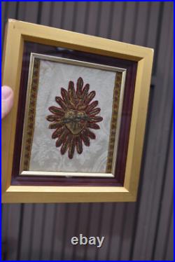 Antique religious plaque with lithurgical brocade bleeding hearth inside